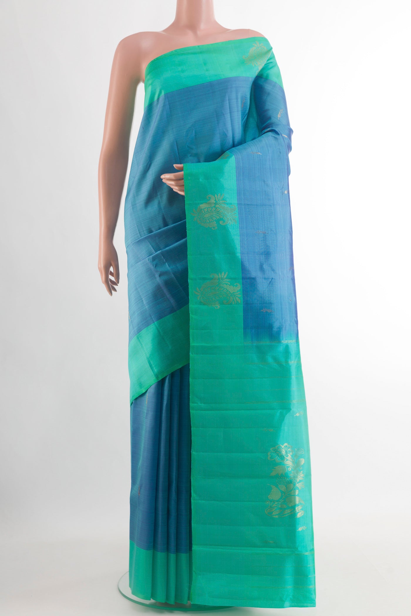 Blue Kanchipuram Silk Saree with Zari Butta on the body and Plain Border.  displayed on a mannequin