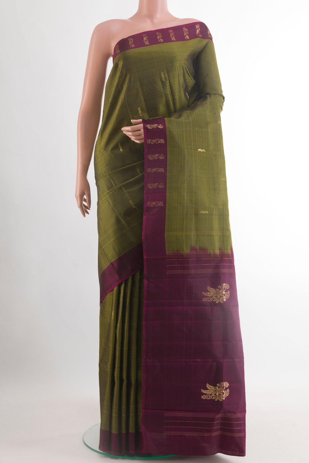 Mehandi Green Kanchipuram Silk Saree with Zari Butta on the body and Plain Border.  displayed on a mannequin