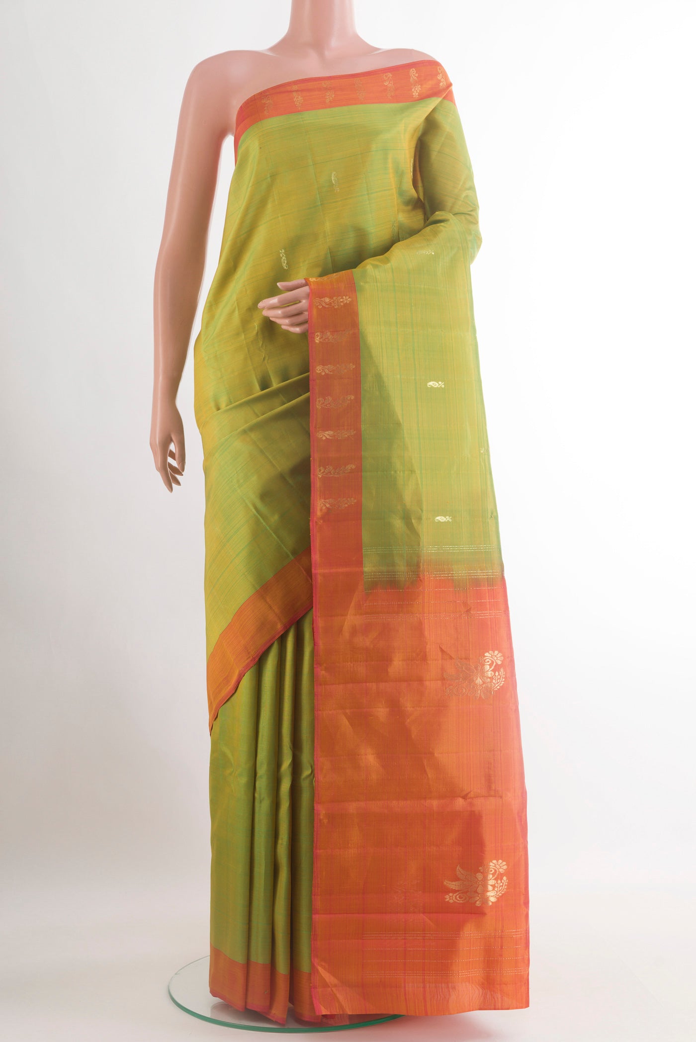Green Kanchipuram Silk Saree with Zari Butta on the body and Plain Border.  displayed on a mannequin