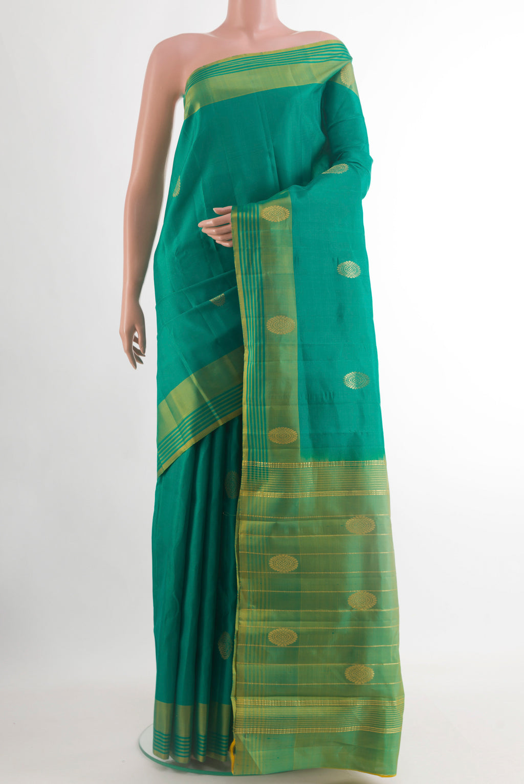 Green Kanchipuram Silk Saree with Zari Butta on the body and Plain Border.  displayed on a mannequin