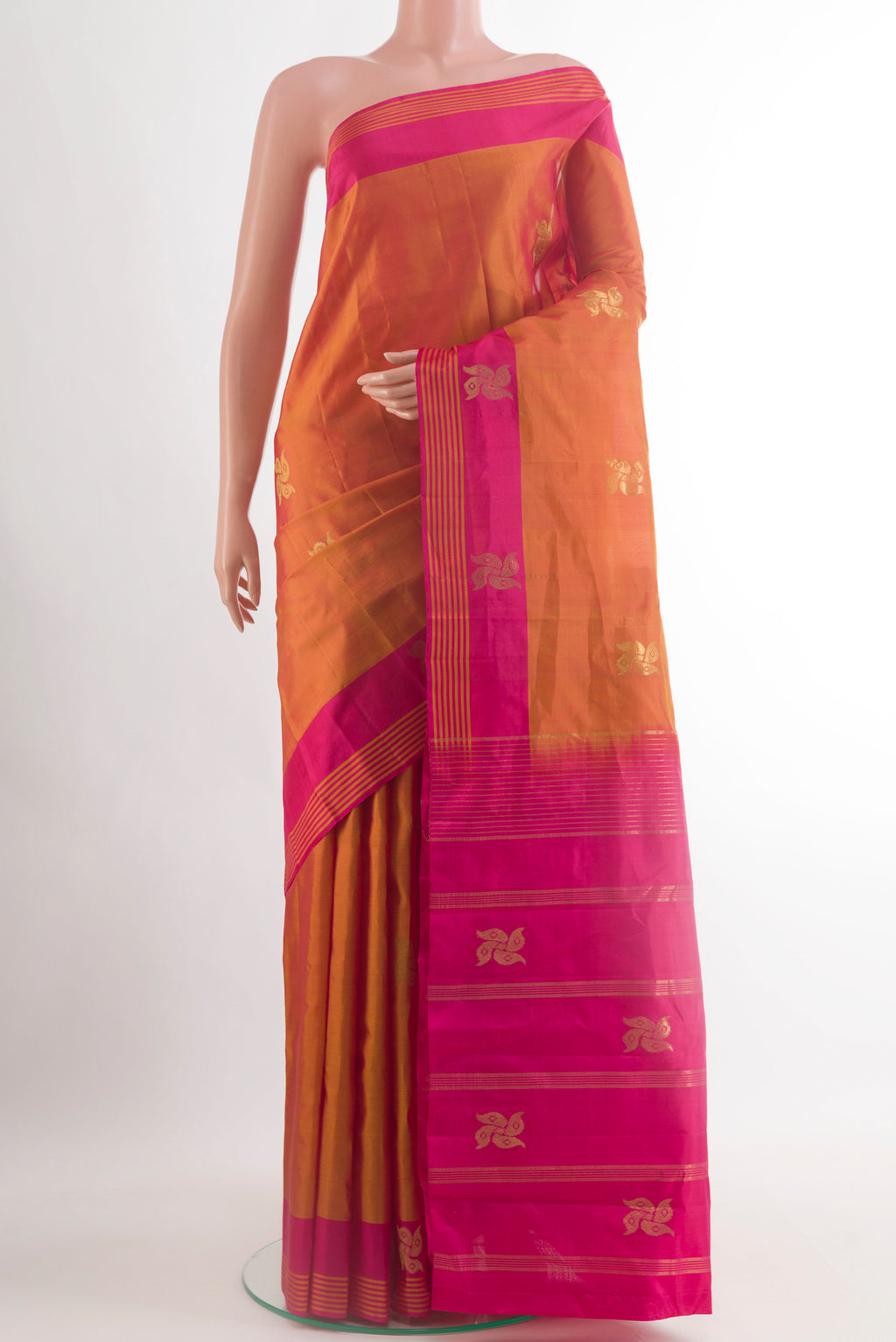 Brick Orange Kanchipuram Silk Saree with Zari Butta on the body and Plain Border.  displayed on a mannequin