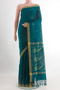 Peacock Blue Uppada Silk Saree with Zari Butta on the body and Zari Border.  displayed on a mannequin
