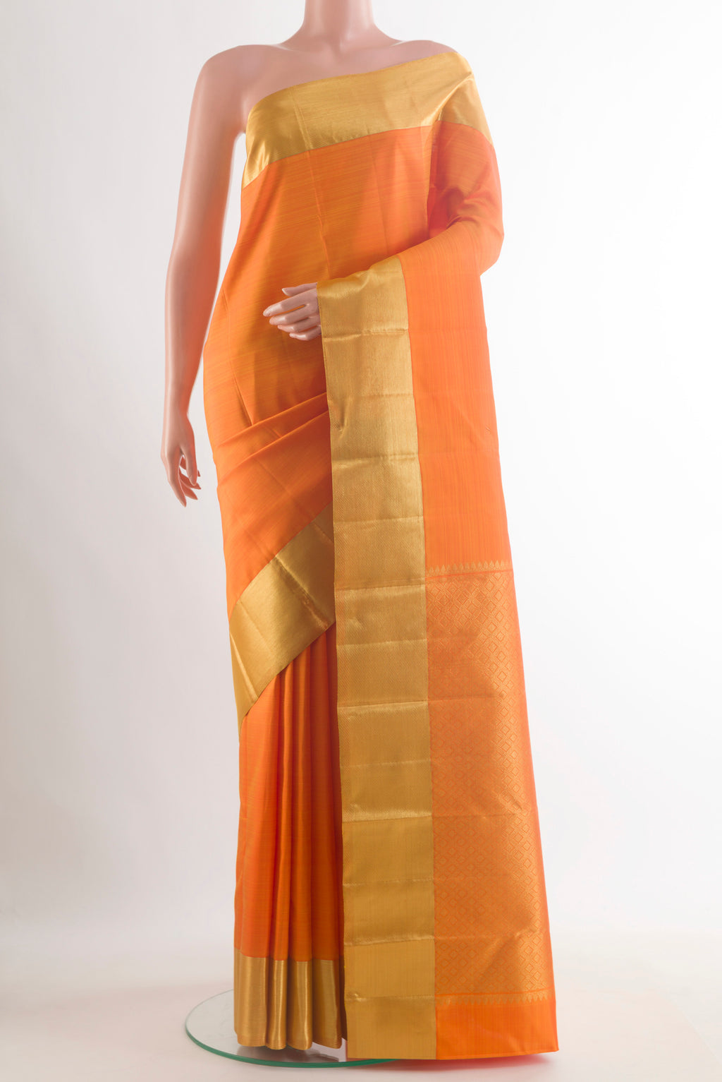 Pure Silk Orange Kanjivaram Saree with Plain Body and Zari Border.  displayed on a mannequin