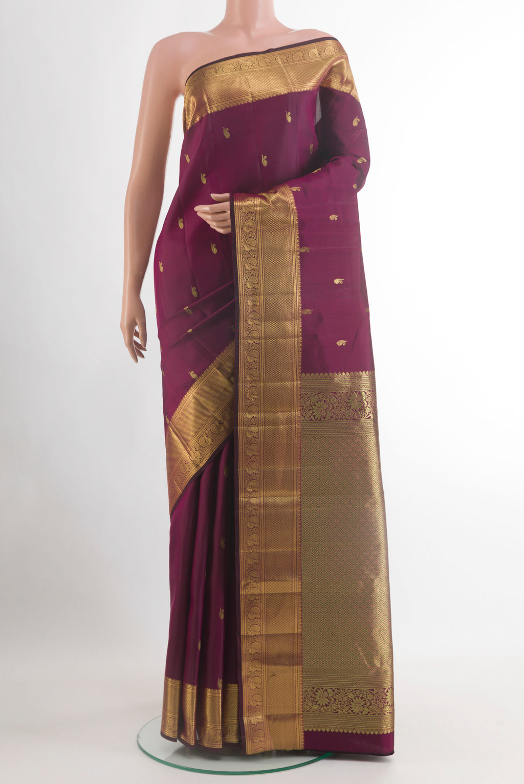 Purple Kanjivaram Silk Saree with Zari Butta on the body and Zari Border.  displayed on a mannequin