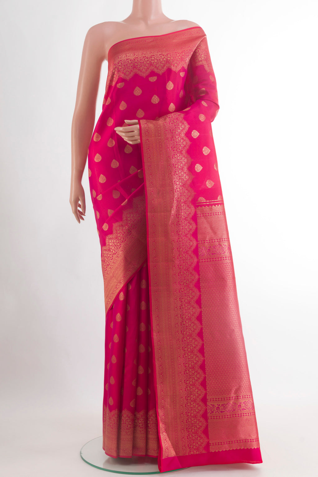 Pink Kanchipuram Silk Saree with Zari Butta on the body and Zari Border.  displayed on a mannequin