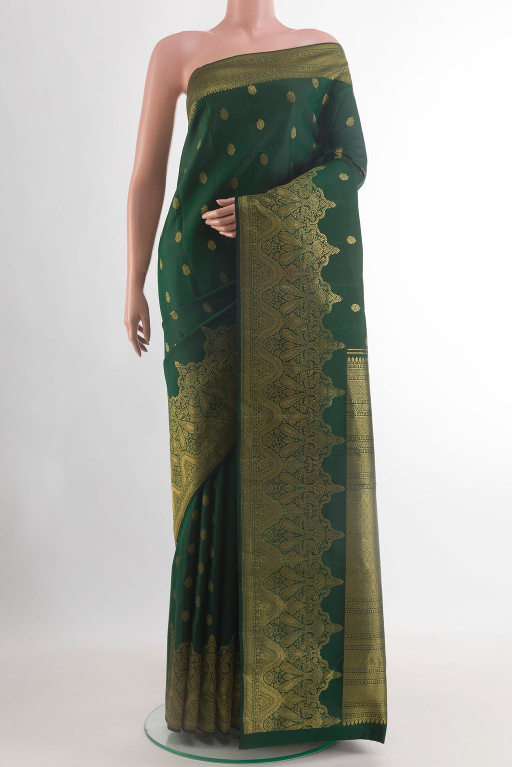 Bottle Green Kanchipuram Silk Saree with Zari Butta on the body and Zari Border.  displayed on a mannequin