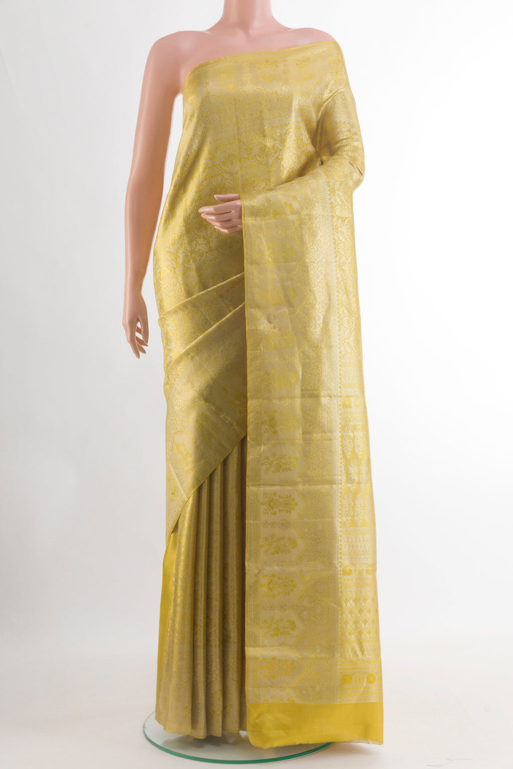 Golden Kanchipuram Silk Saree with Zari Brocade on the body and Zari Border.  displayed on a mannequin