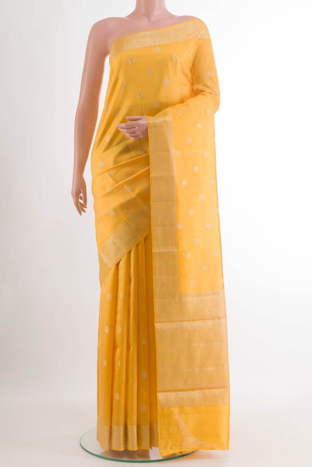 Yellow Banarasi Raw Silk Saree with Zari Butta on the body and Zari Border.  displayed on a mannequin