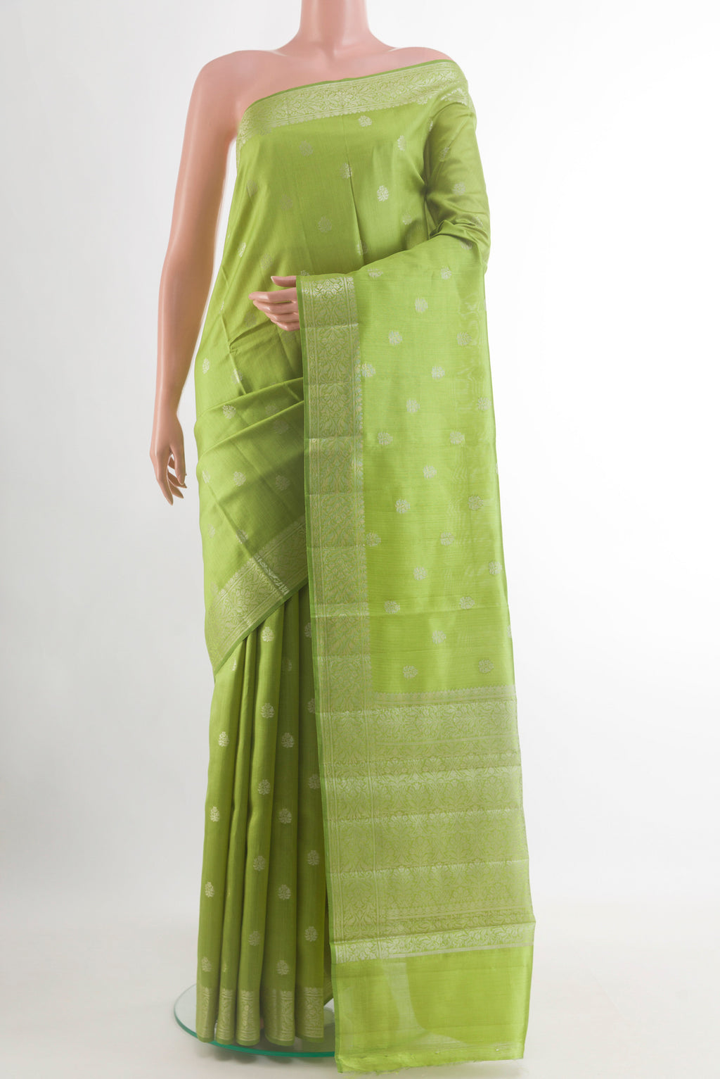 Green Banarasi Raw Silk Saree with Zari Butta on the body and Zari Border.  displayed on a mannequin