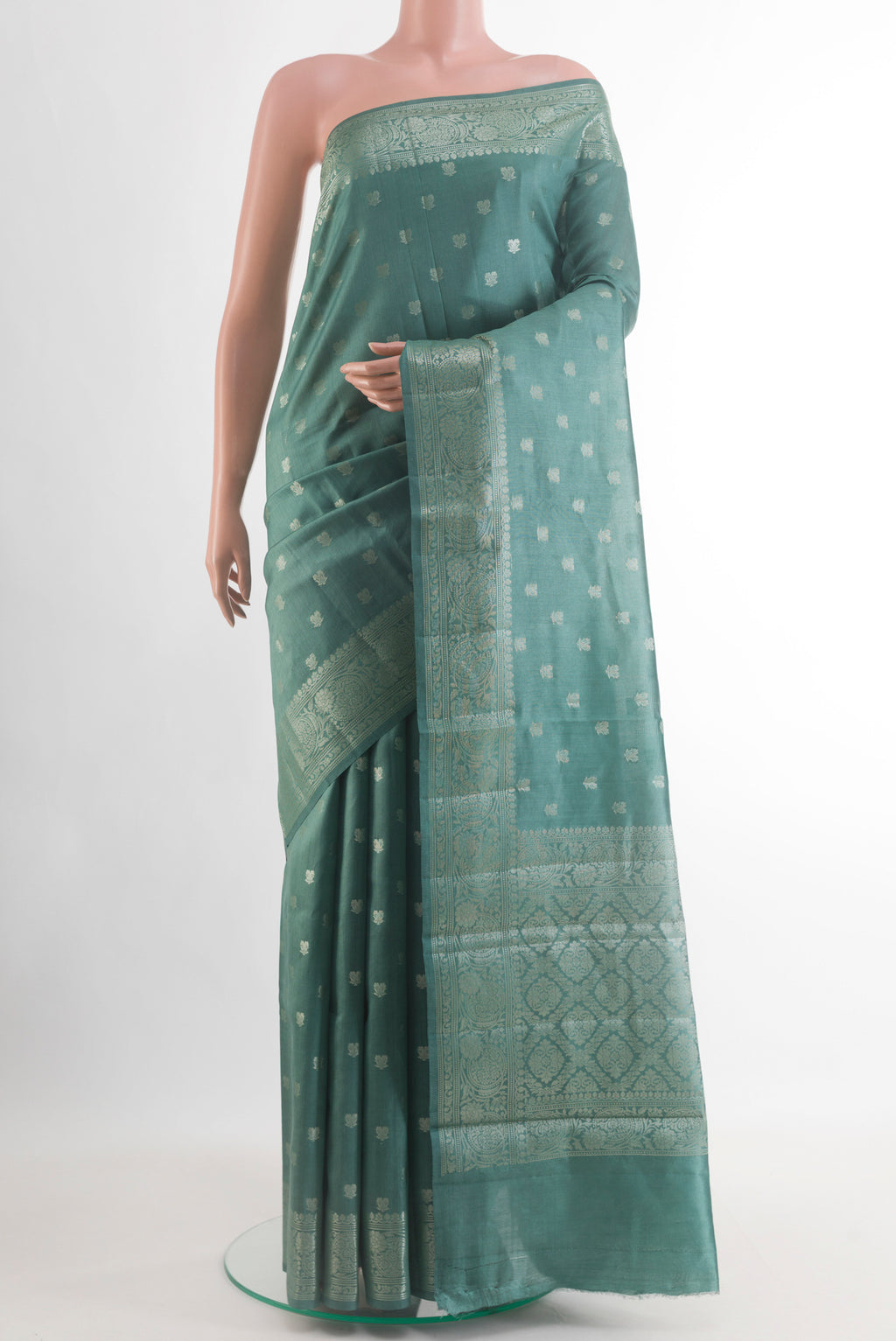 Sage Green Banarasi Raw Silk Saree with Zari Butta on the body and Zari Border.  displayed on a mannequin
