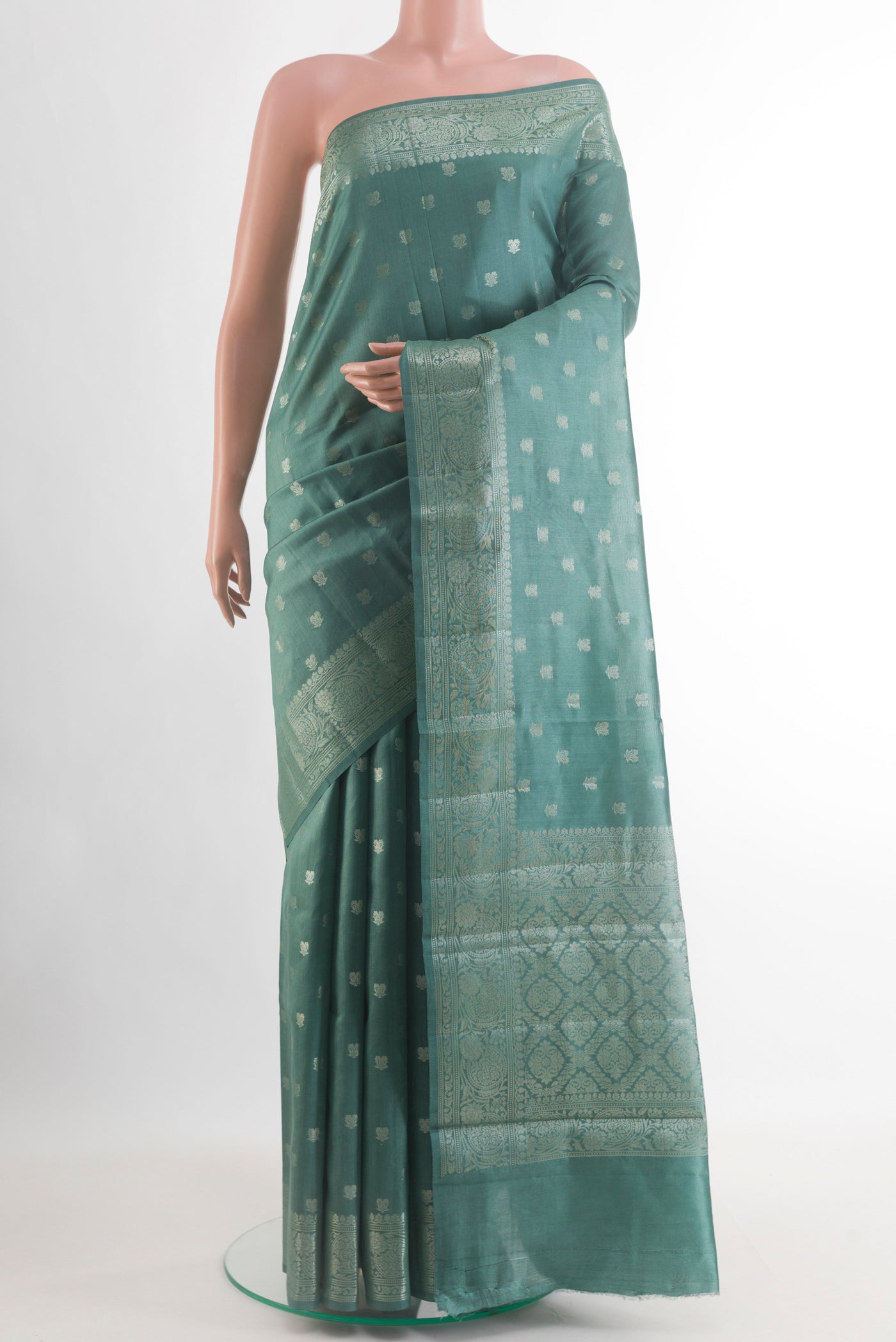 Sage Green Banarasi Raw Silk Saree with Zari Butta on the body and Zari Border.  displayed on a mannequin