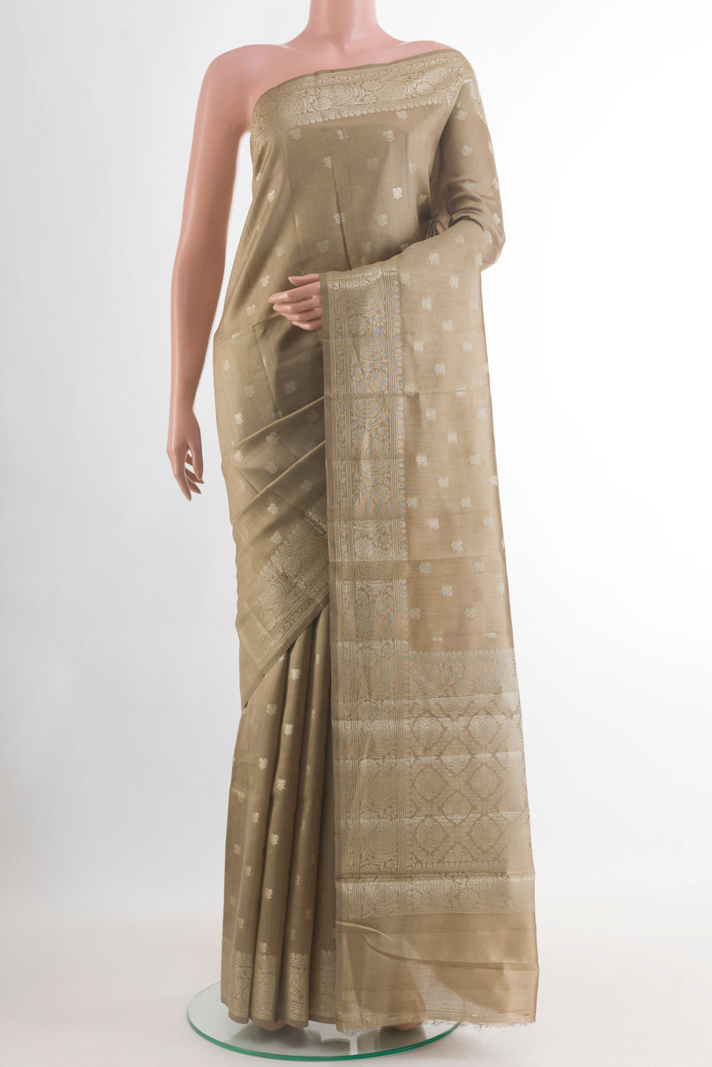 Beige Banarasi Raw Silk Saree with Zari Butta on the body and Zari Border.  displayed on a mannequin