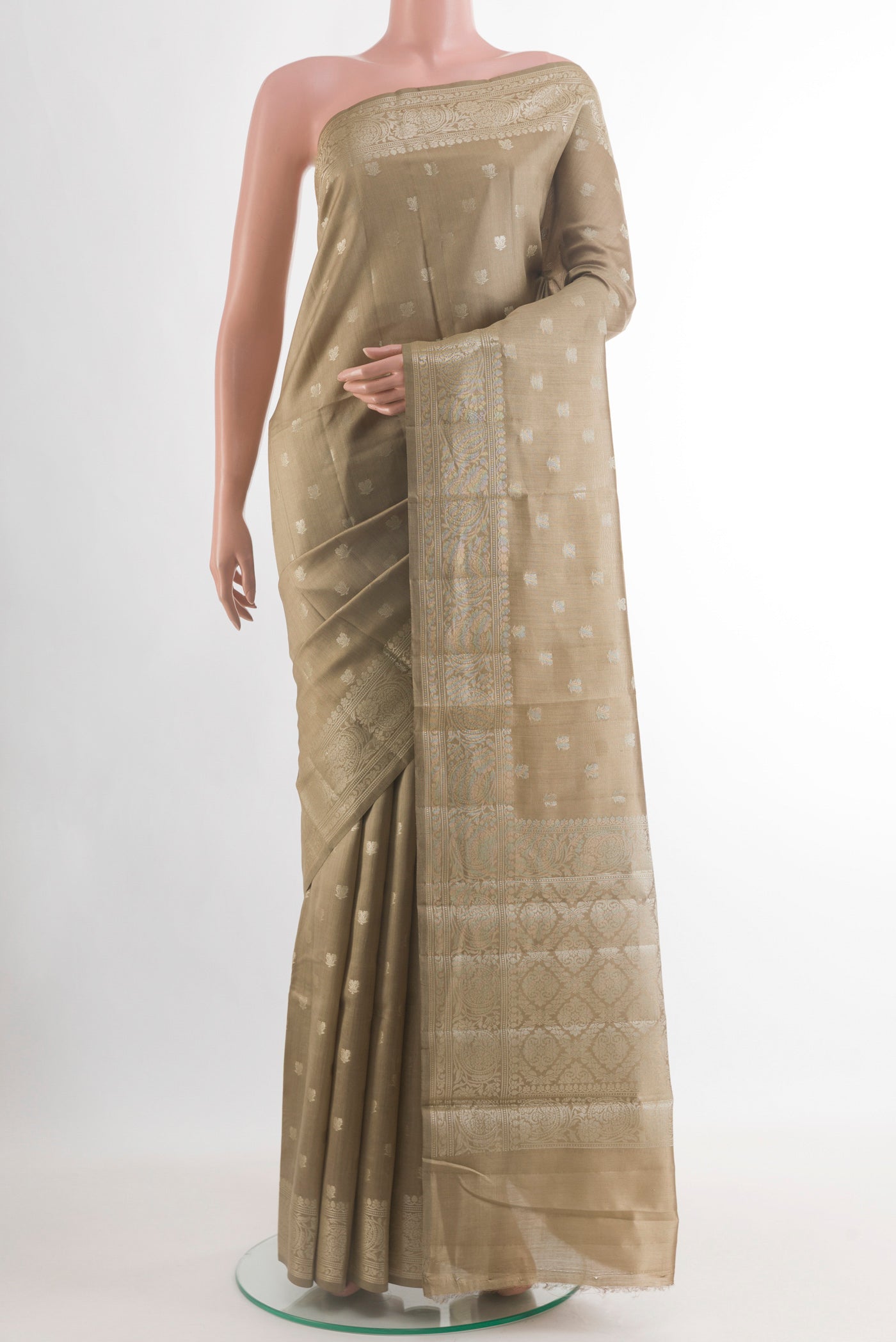 Beige Banarasi Raw Silk Saree with Zari Butta on the body and Zari Border.  displayed on a mannequin