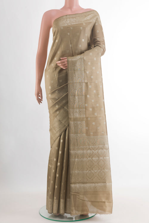 Beige Banarasi Raw Silk Saree with Zari Butta on the body and Zari Border.  displayed on a mannequin