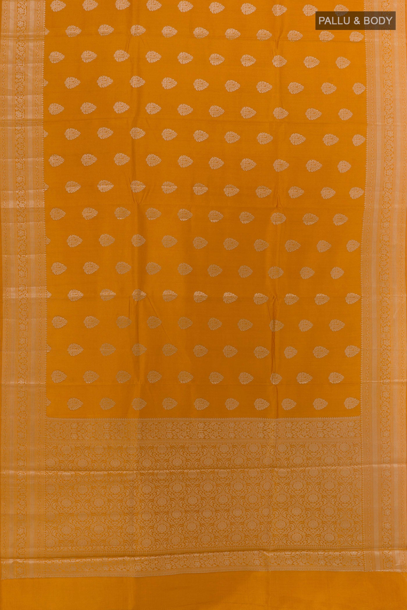Flat view of Mustard Banarasi Raw Silk Saree with Zari Butta on the body and Zari Border. 