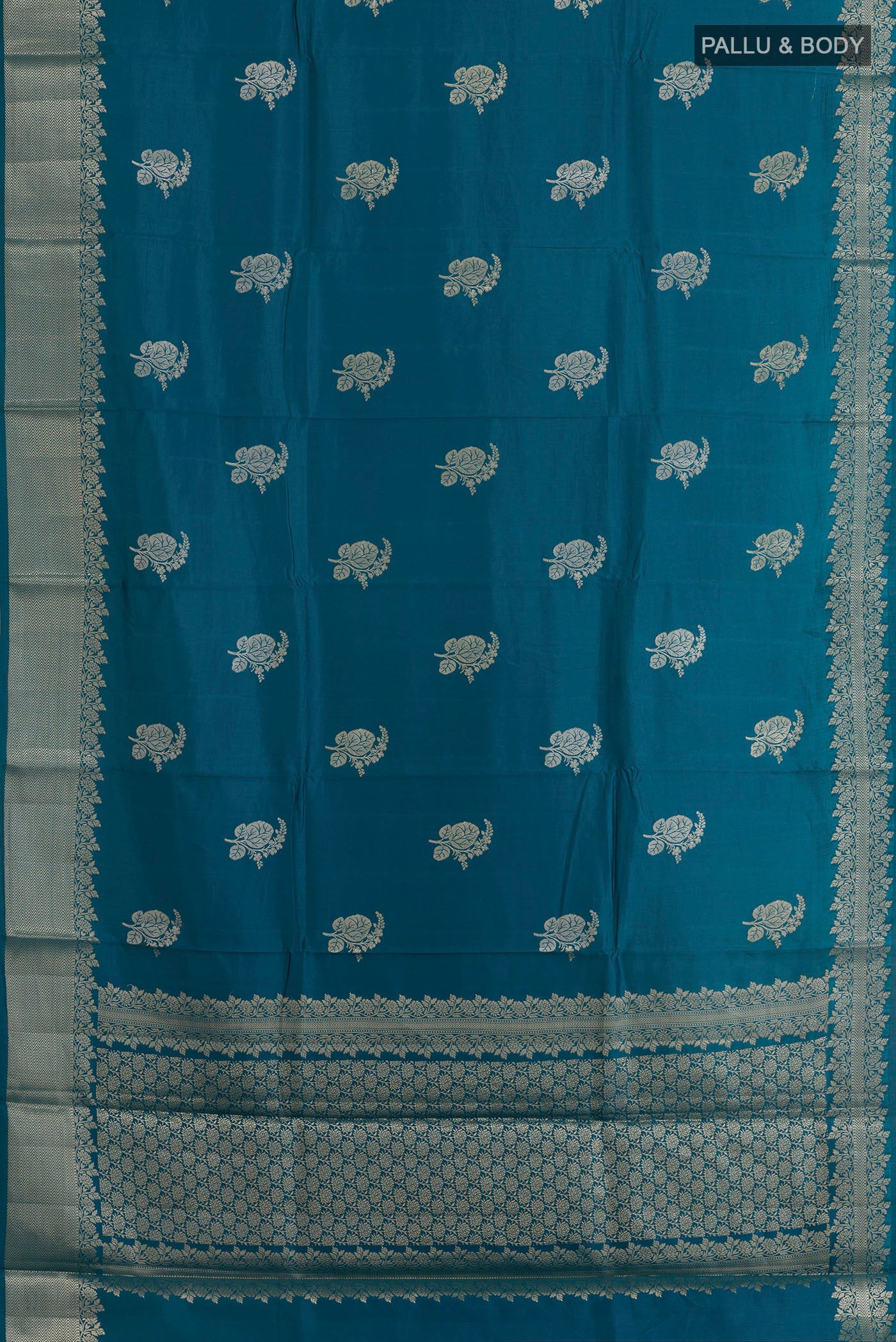 Flat view of Blue Banarasi Raw Silk Saree with Zari Butta on the body and Zari Border. 
