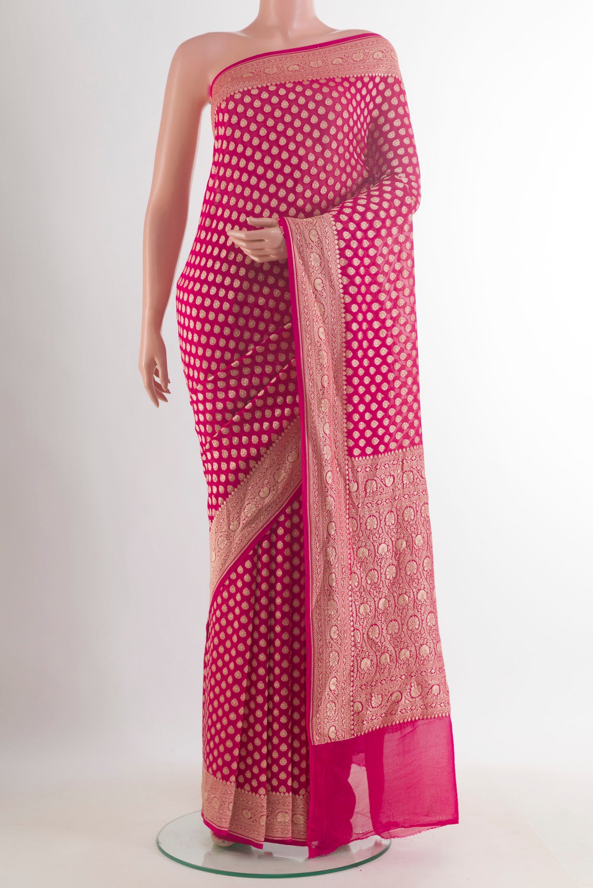 Pink Banarasi Georgette Saree with Zari Butta on the body and Zari Border.  displayed on a mannequin