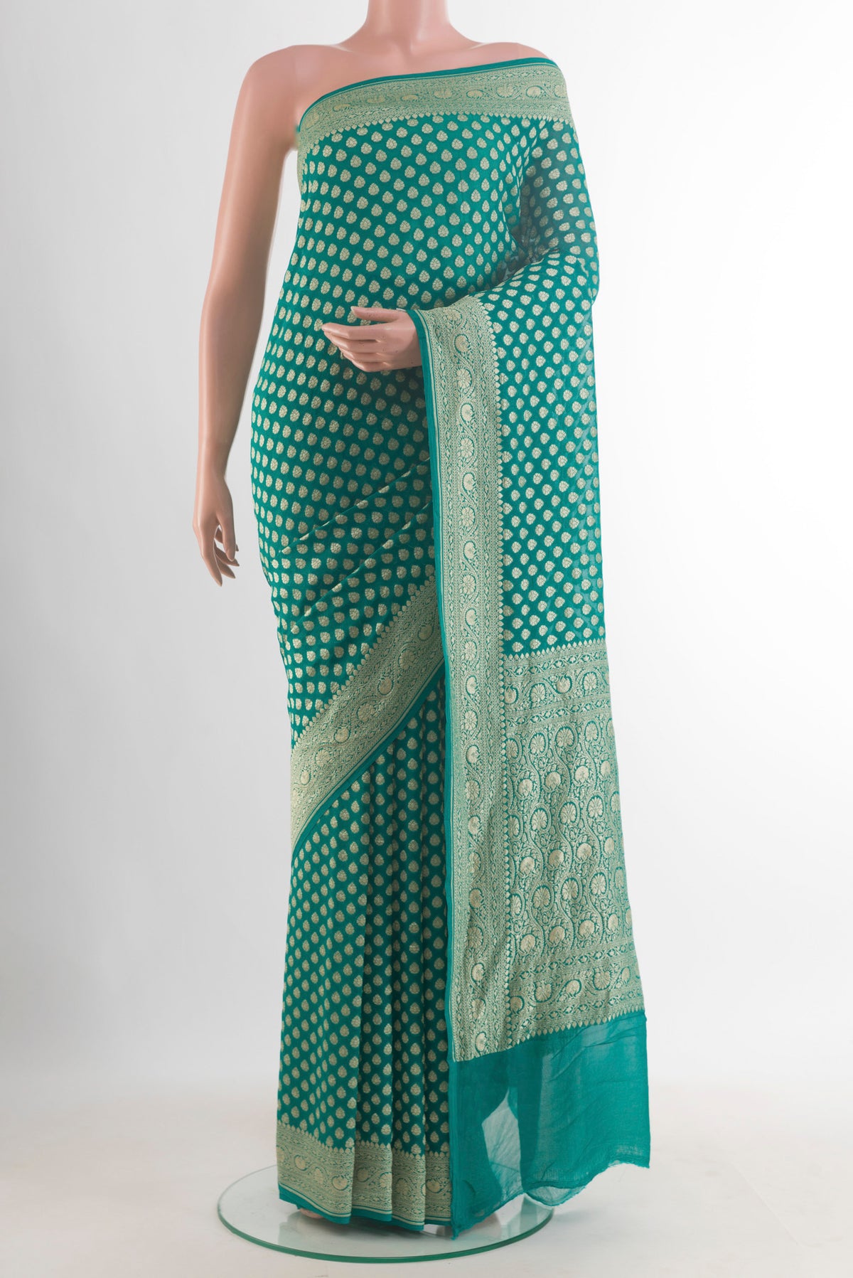 Sea Green Banarasi Georgette Saree with Zari Butta on the body and Zari Border.  displayed on a mannequin