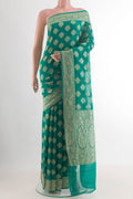 Sea Green Banarasi Georgette Saree with Zari Brocade on the body and Zari Border.  displayed on a mannequin