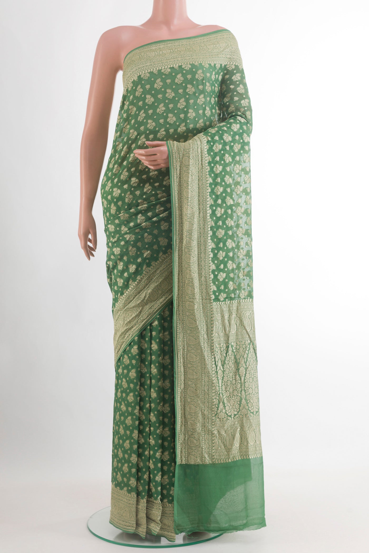 Sage Green Banarasi Georgette Saree with Zari Brocade on the body and Zari Border.  displayed on a mannequin