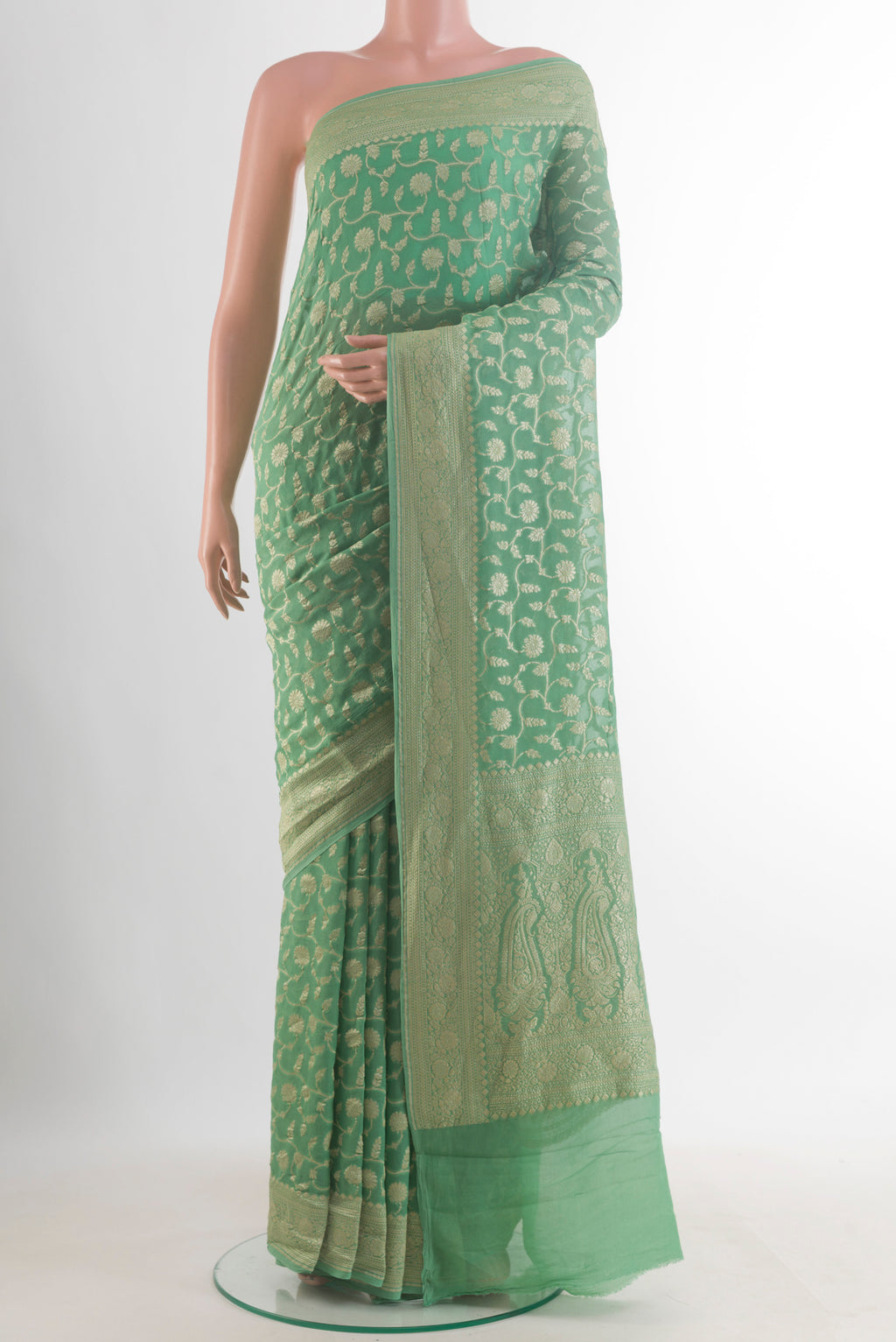Green Banarasi Georgette Saree with Zari Brocade on the body and Zari Border.  displayed on a mannequin