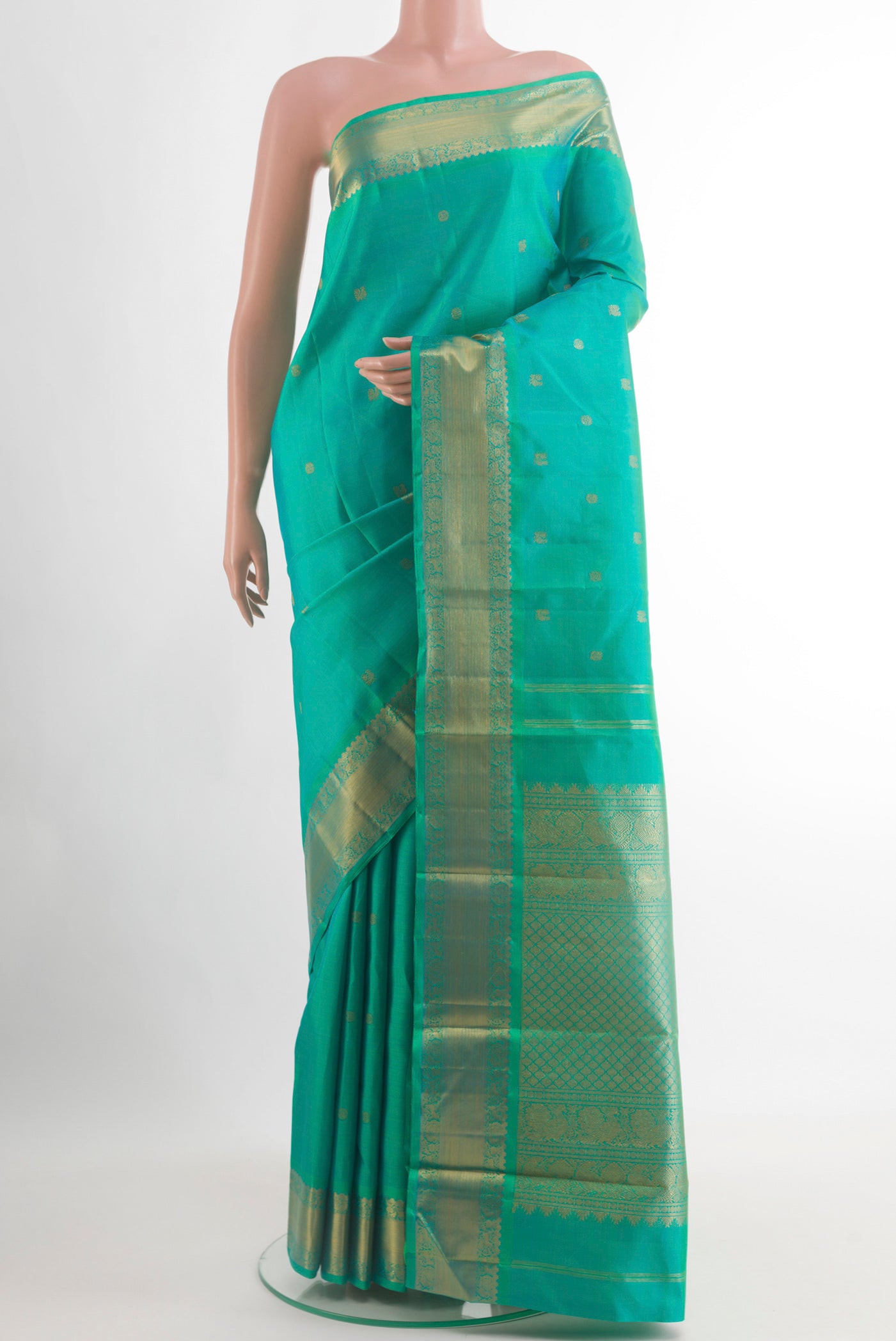 Turquoise Kanchipuram Silk Saree with Zari Butta on the body and Zari Border.  displayed on a mannequin