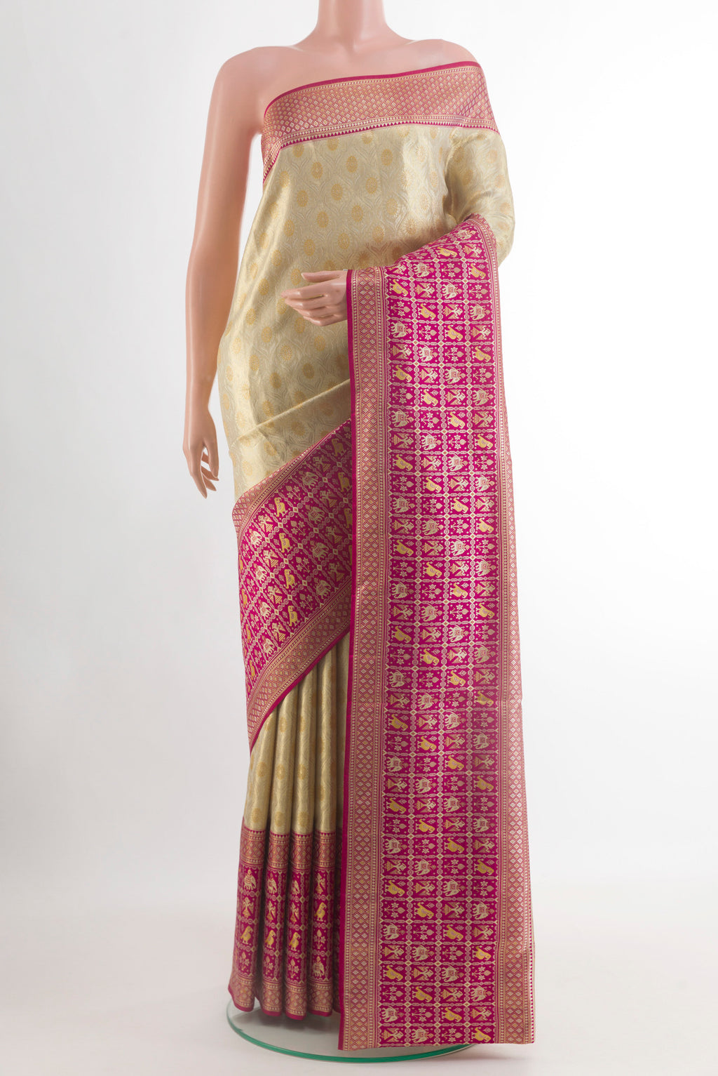 Cream Kanchipuram Tissue Silk Saree with Zari Brocade on the body and Zari Border.  displayed on a mannequin
