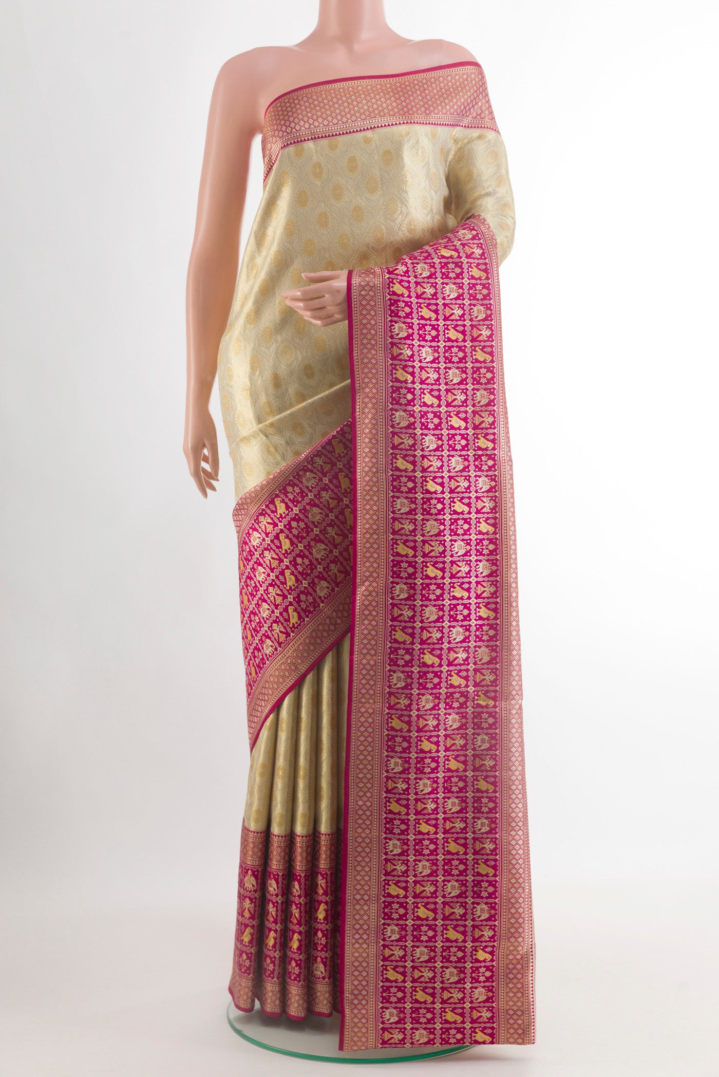 Cream Kanchipuram Tissue Silk Saree with Zari Brocade on the body and Zari Border.  displayed on a mannequin