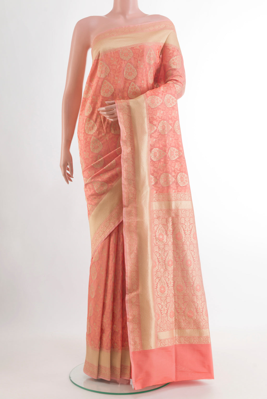 Peach Banarasi Silk Saree with Zari And Thread Butta on the body and Zari Border.  displayed on a mannequin