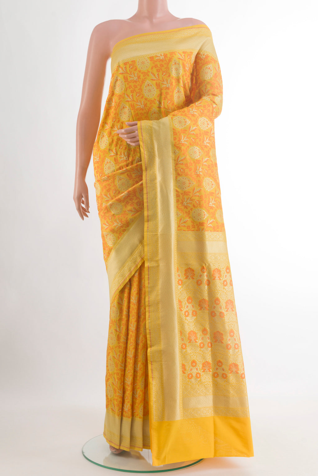 Yellow Banarasi Silk Saree with Zari And Thread Butta on the body and Zari Border.  displayed on a mannequin
