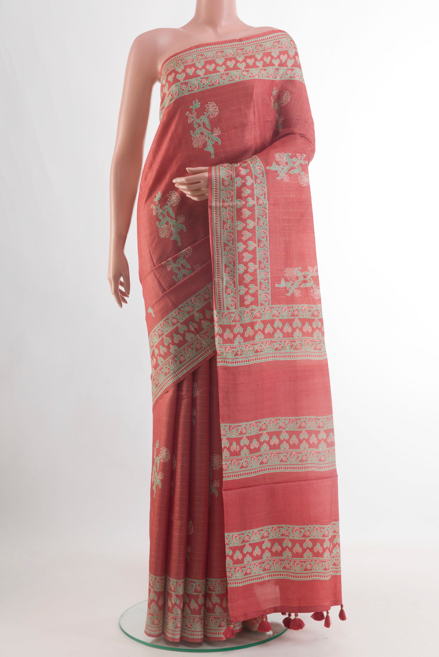 Rust Tussar Silk Saree with Printed design on the body and Printed Border.  displayed on a mannequin