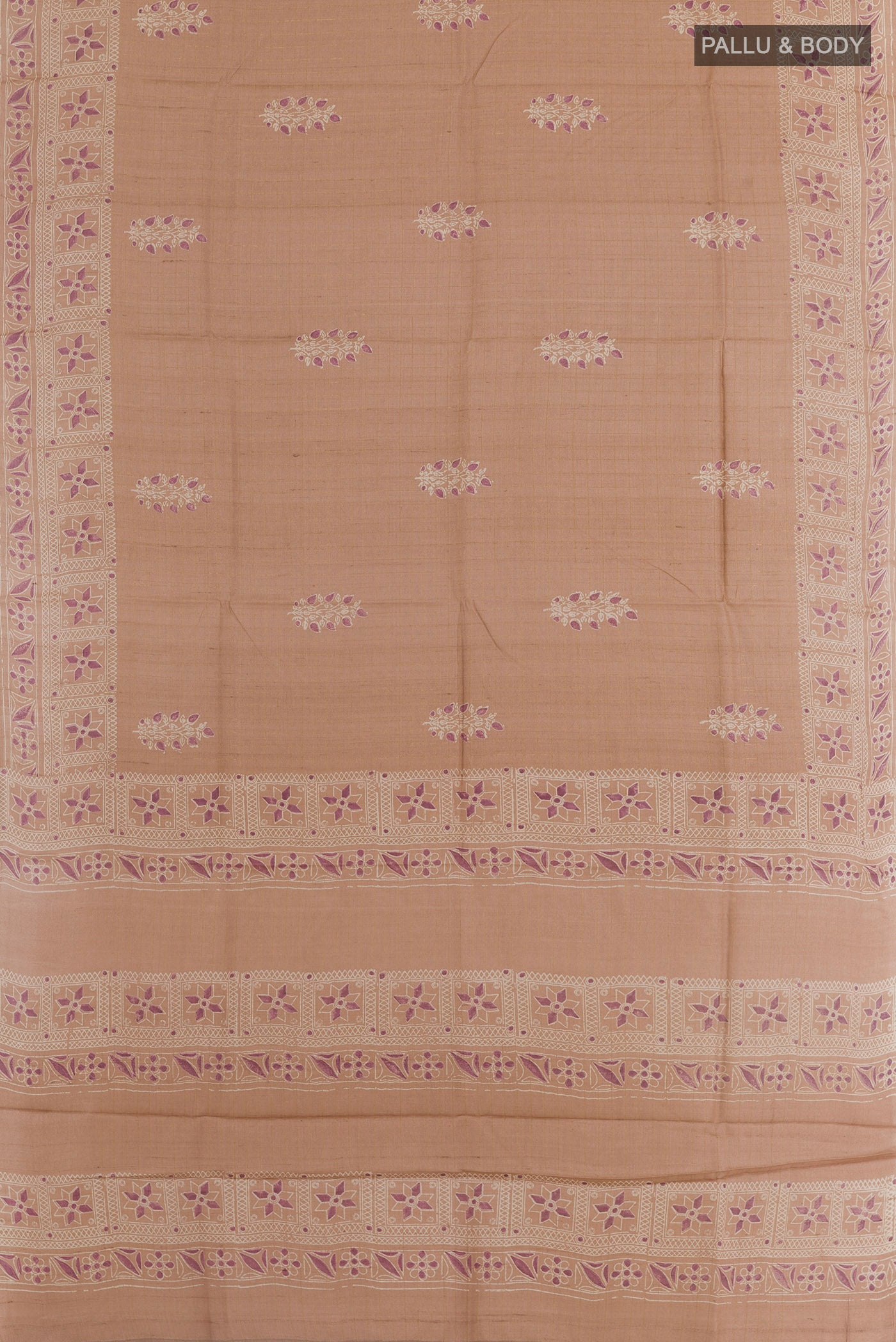 Flat view of Rose Gold Tussar Saree with Printed design on the body and Zari Border. 
