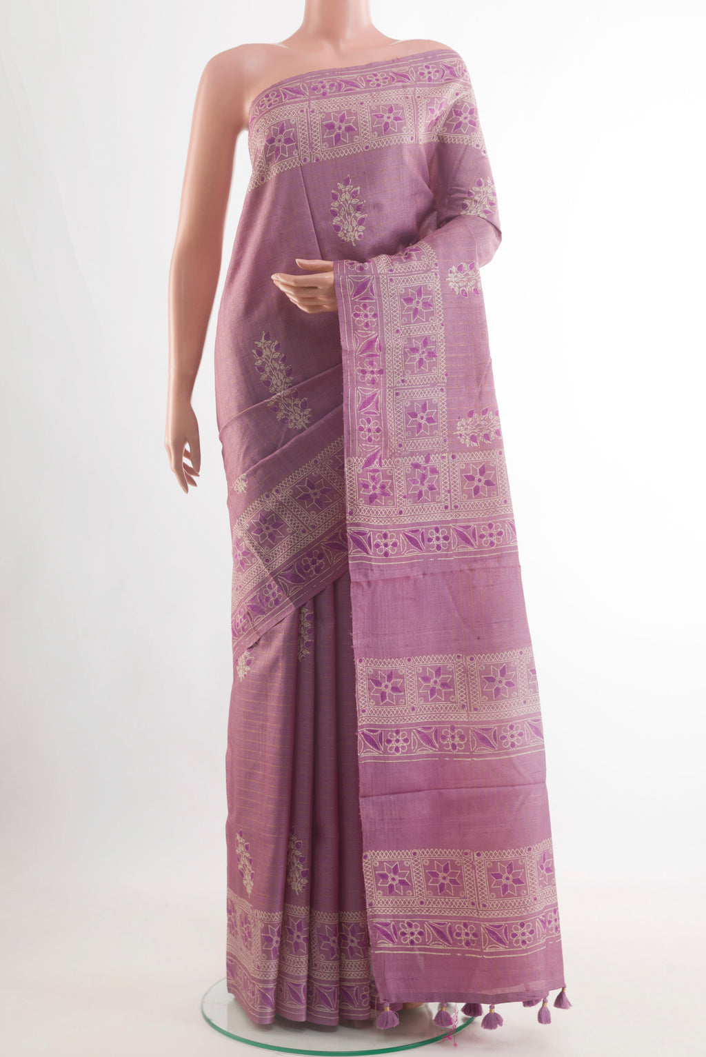 Lavender Tussar Saree with Printed design on the body and Zari Border.  displayed on a mannequin
