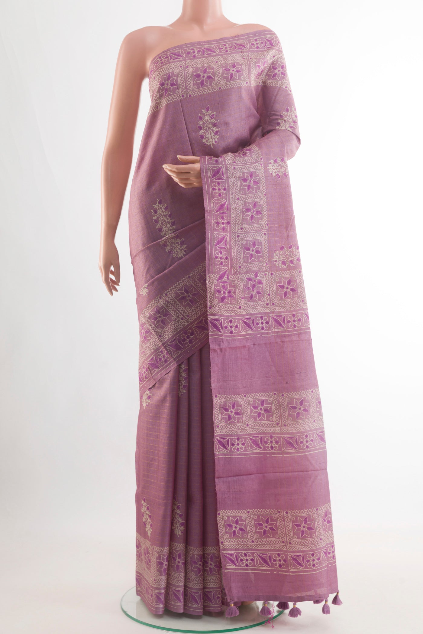 Lavender Tussar Saree with Printed design on the body and Zari Border.  displayed on a mannequin