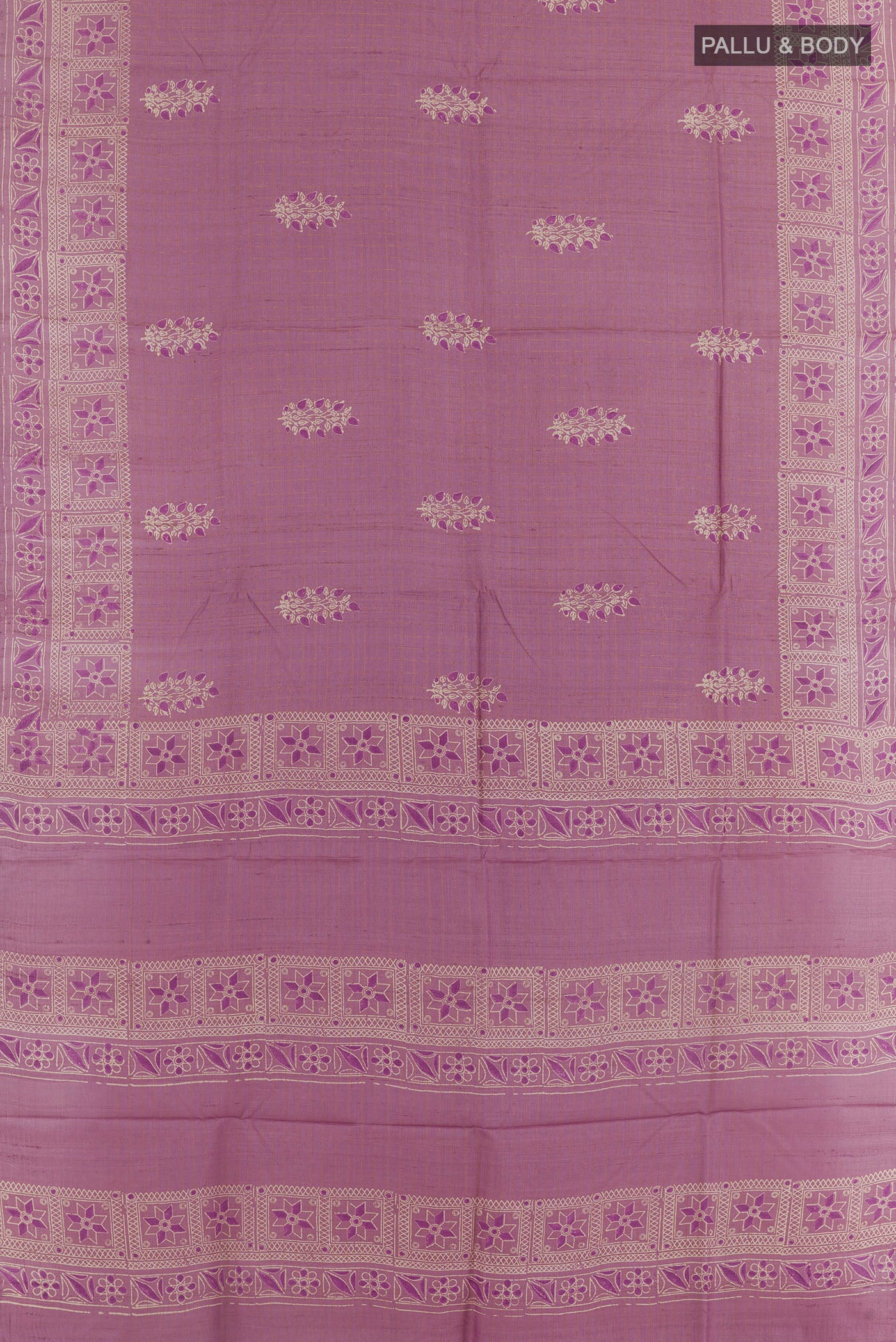 Flat view of Lavender Tussar Saree with Printed design on the body and Zari Border. 