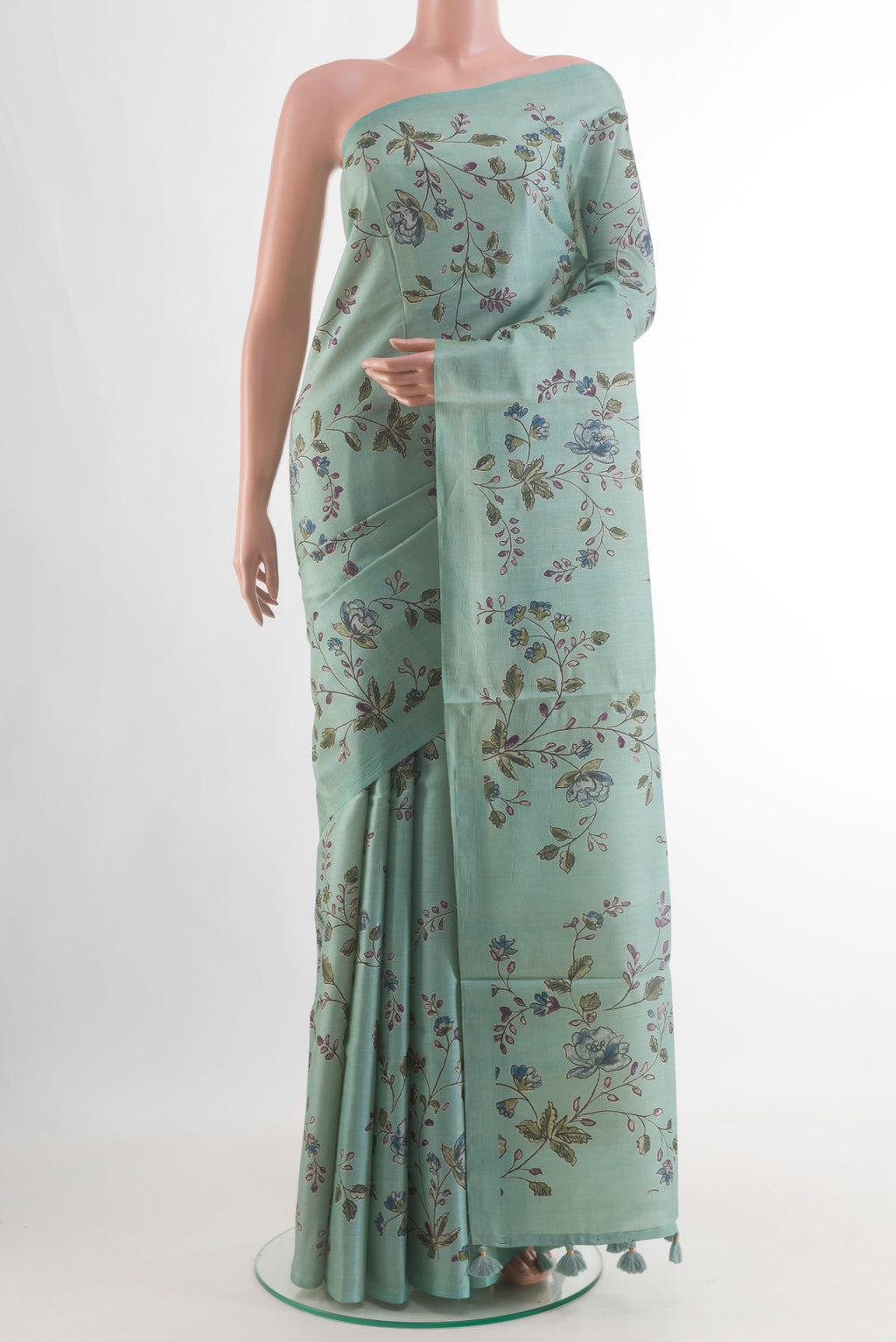 Mint Green Tussar Silk Saree with Printed design on the body and Without Border.  displayed on a mannequin