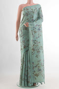 Mint Green Tussar Silk Saree with Printed design on the body and Without Border.  displayed on a mannequin