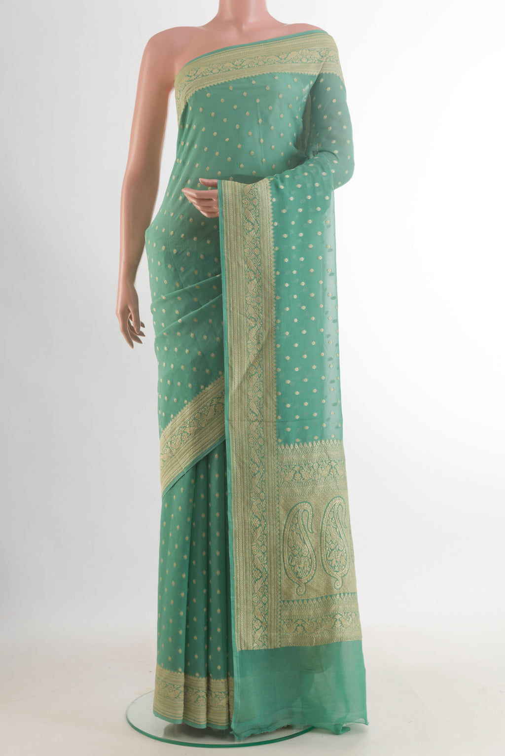 Mint Green Banarasi Georgette Saree with Zari Butta on the body and Zari Border.  displayed on a mannequin