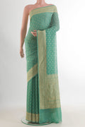 Mint Green Banarasi Georgette Saree with Zari Butta on the body and Zari Border.  displayed on a mannequin