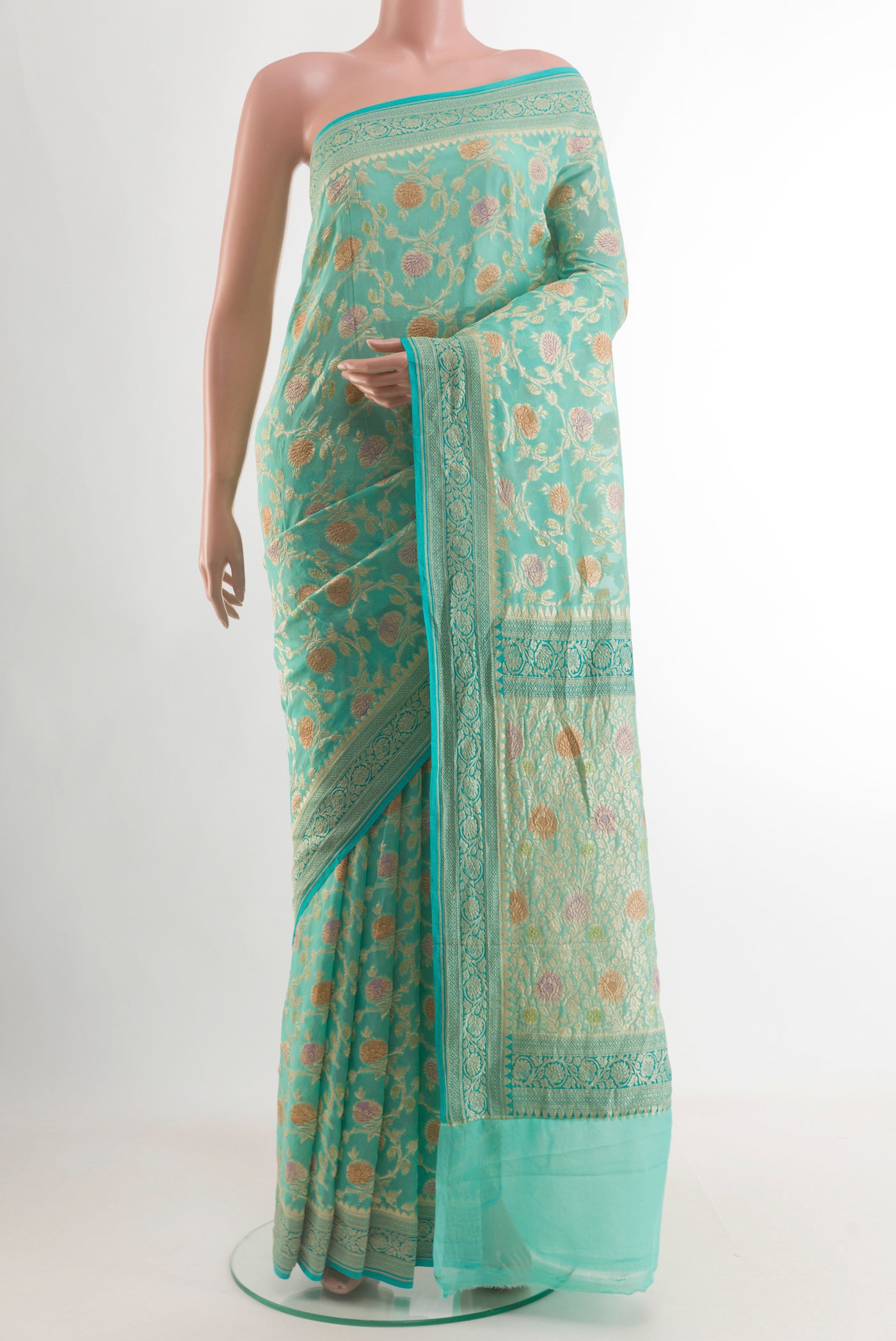 Turquoise Banarasi Georgette Saree with Zari Brocade on the body and Zari Border.  displayed on a mannequin