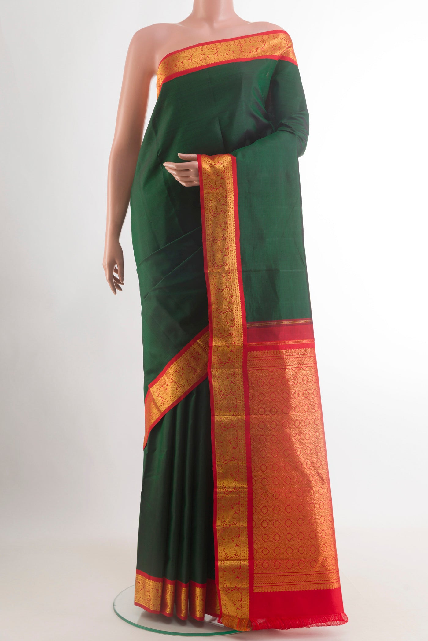 Bottle Green Kanjivaram Silk Saree with Plain Body and Zari Border.  displayed on a mannequin