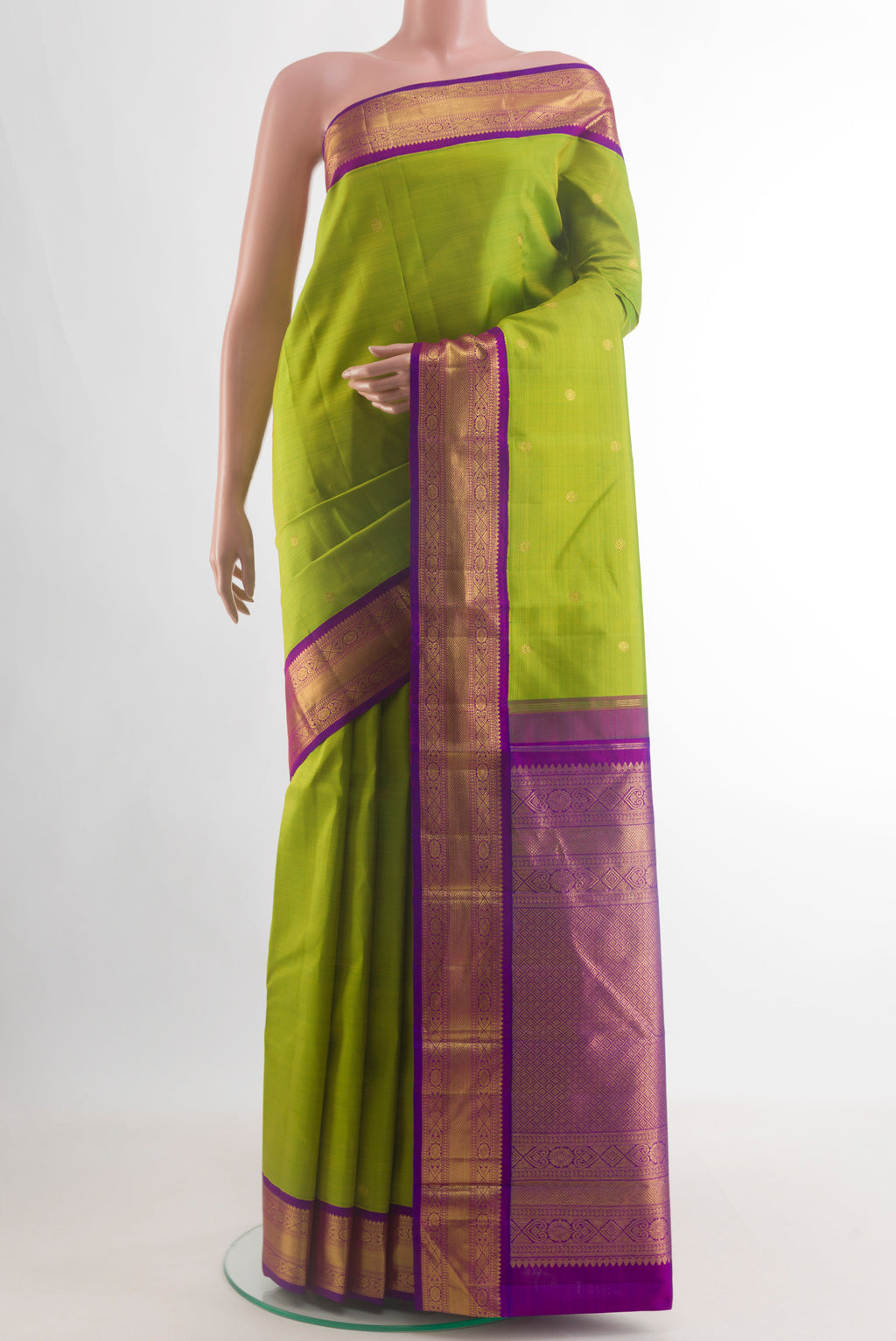 Green Kanjivaram Silk Saree with Zari Butta on the body and Zari Border.  displayed on a mannequin