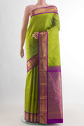 Green Kanjivaram Silk Saree with Zari Butta on the body and Zari Border.  displayed on a mannequin