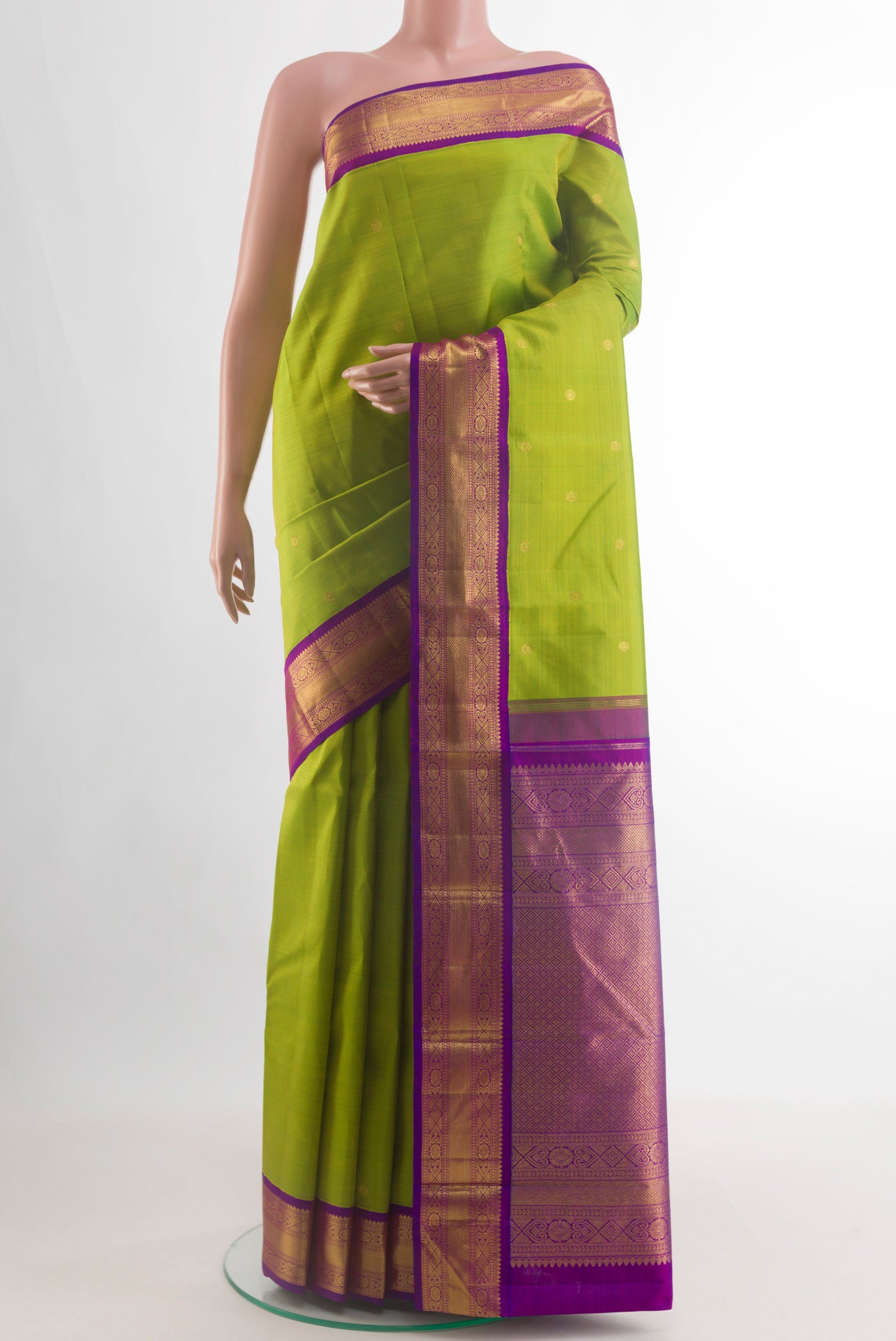Green Kanjivaram Silk Saree with Zari Butta on the body and Zari Border.  displayed on a mannequin