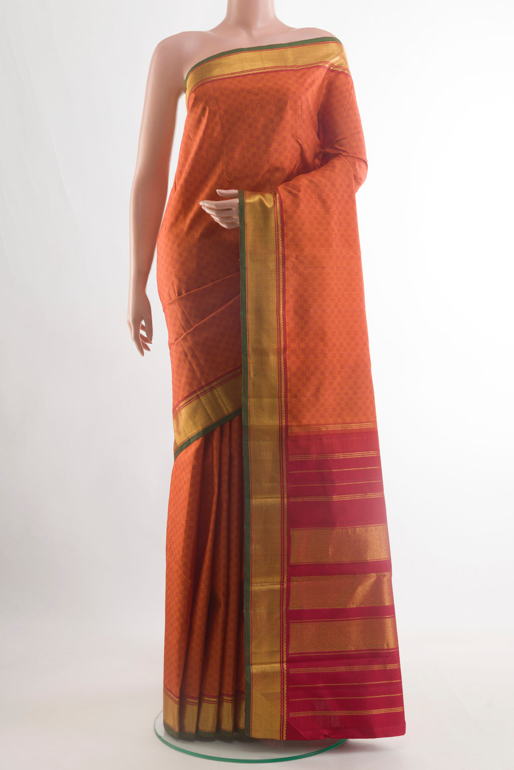 Brick Orange Kanchipuram Silk Saree with Jacquard design on the body and Zari Border.  displayed on a mannequin