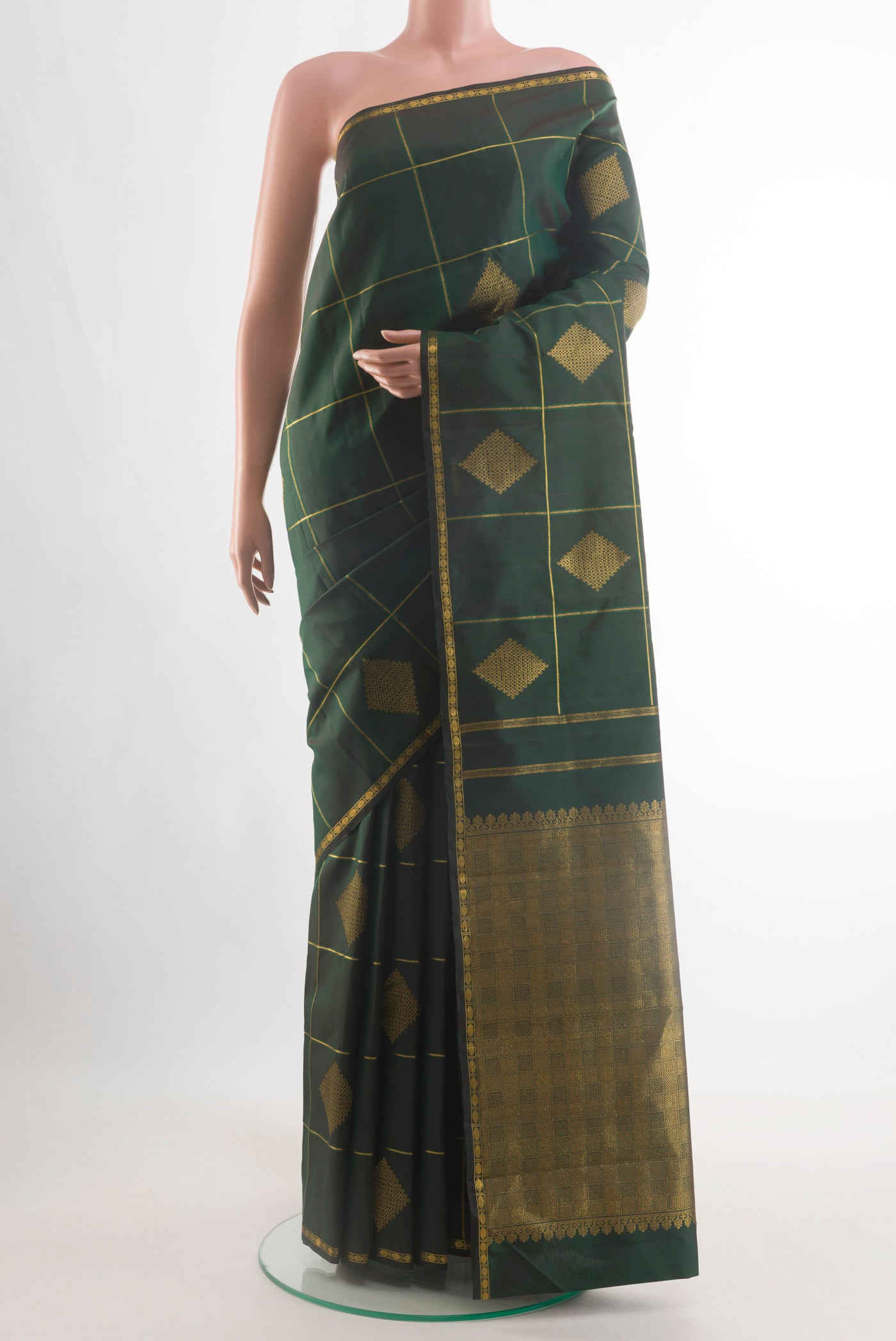 Bottle Green Kanchipuram Silk Saree with Checked design on the body and Zari Border.  displayed on a mannequin