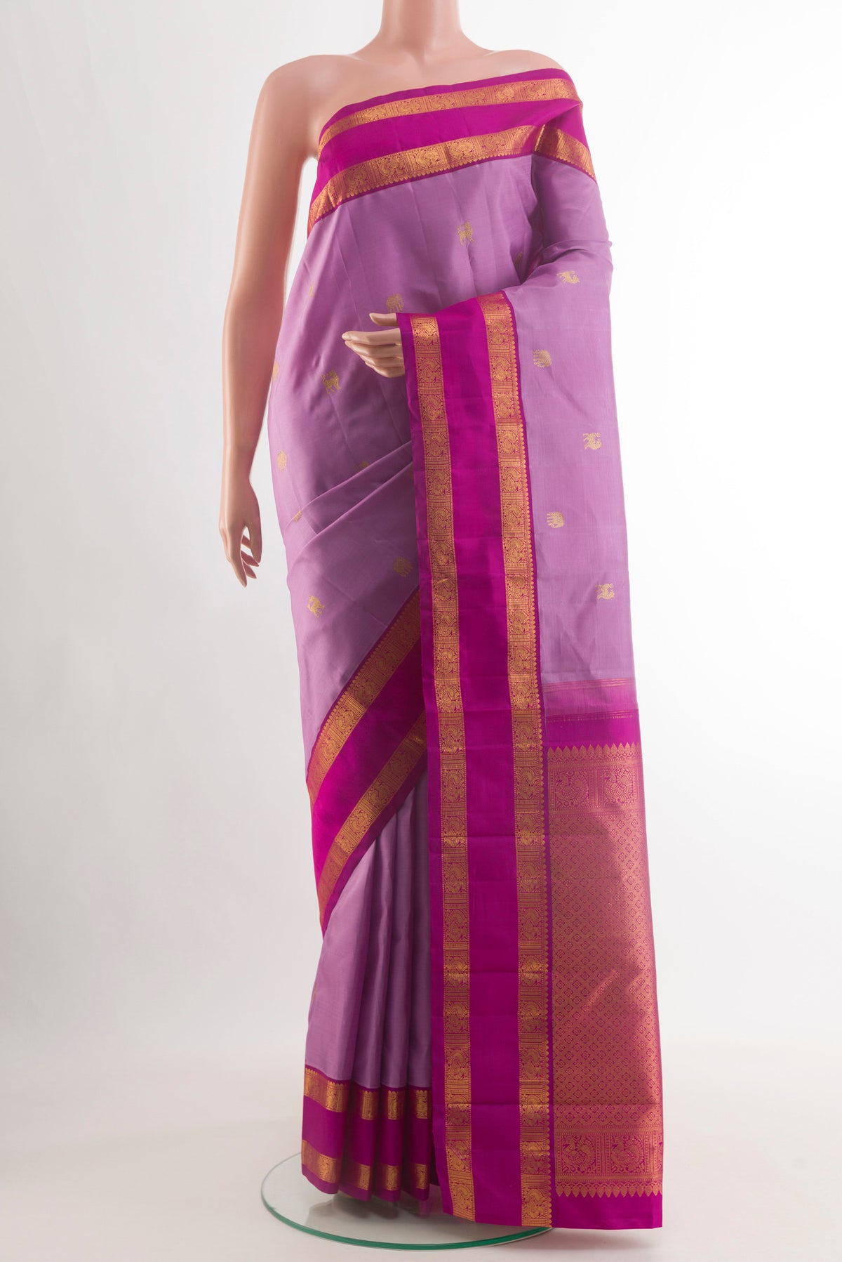 Lavender Kanjivaram Silk Saree with Zari Butta on the body and Zari Border.  displayed on a mannequin