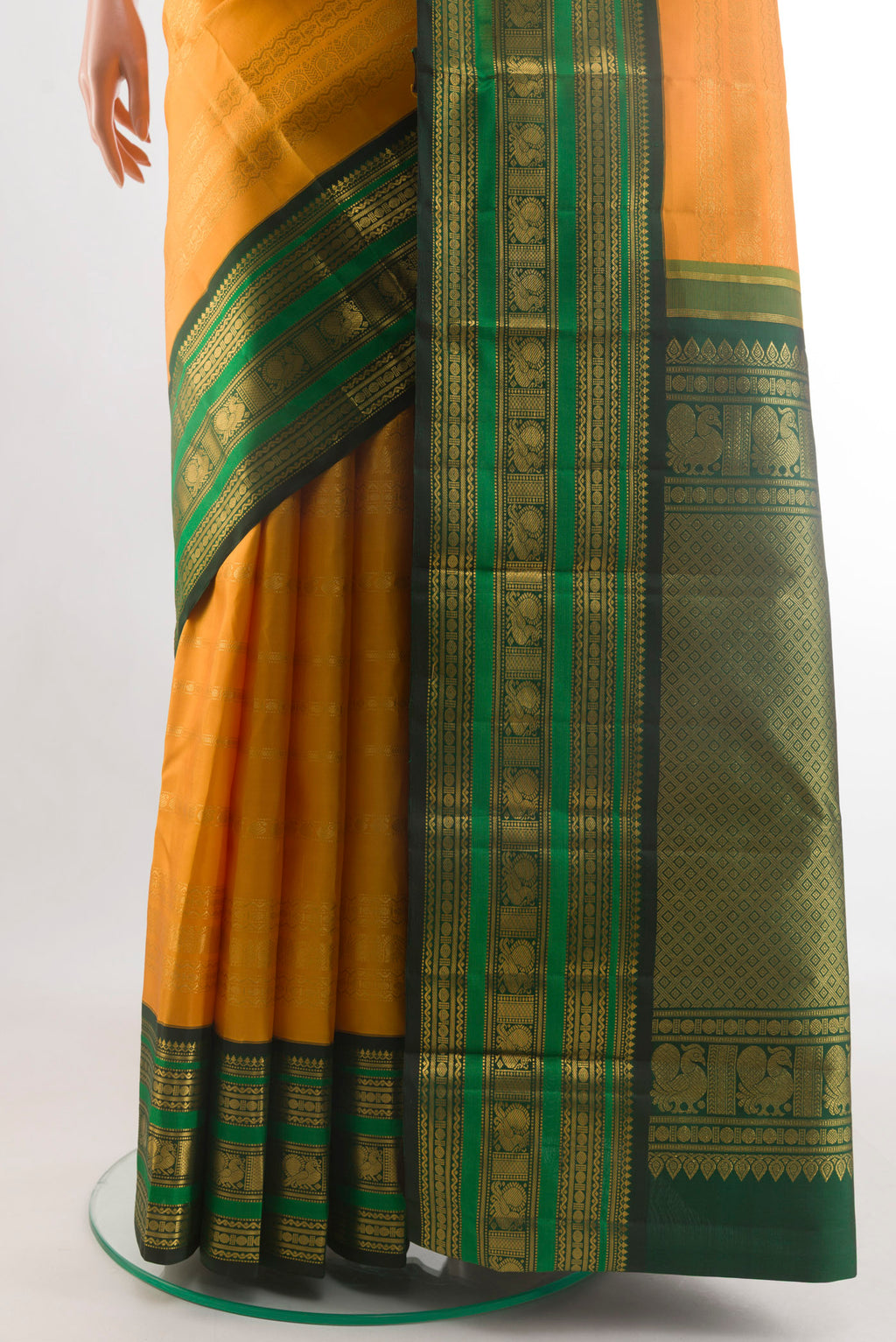 Pleats and pallu of Yellow Kanchipuram Silk Saree with Stripes on the body and Zari Border. 