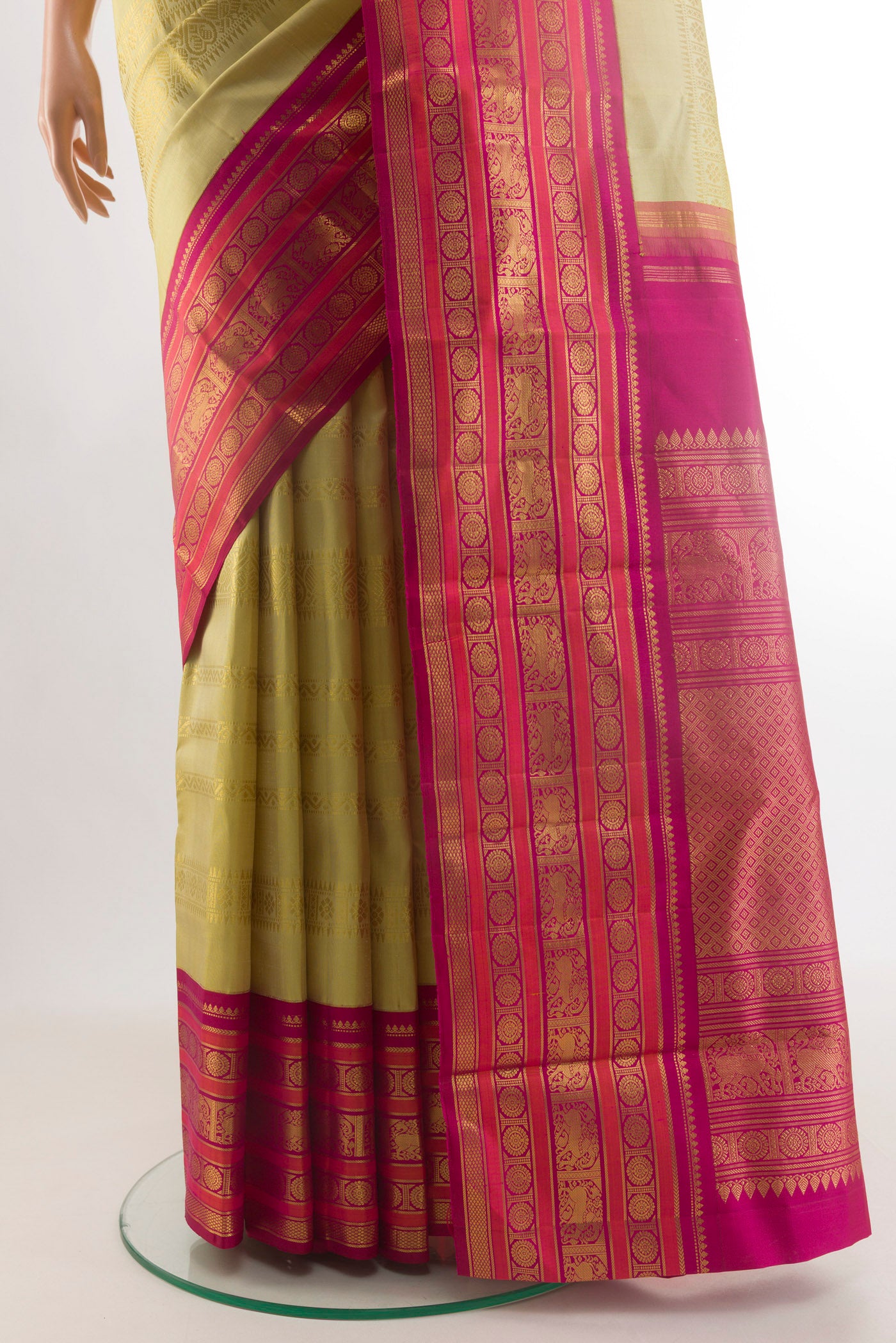 Pleats and pallu of Sandal Kanchipuram Silk Saree with Stripes on the body and Zari Border. 