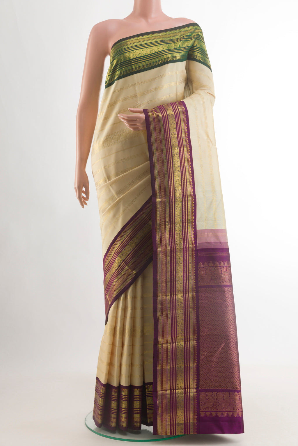 Cream Kanchipuram Silk Saree with Stripes on the body and Ganga Jamuna Border.  displayed on a mannequin